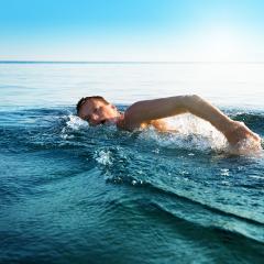 man swimming in ocean