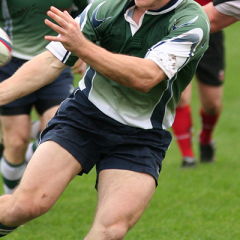 Close up action photo of rugby player passing ball